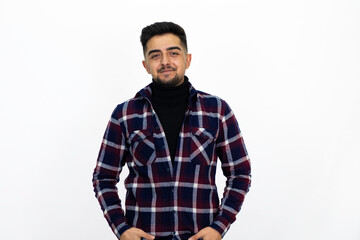 Fototapeta premium Young man posing in the studio. He wears a striped dark shirt.