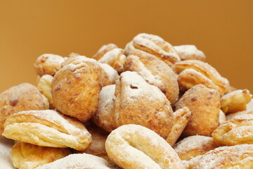 Fresh cottage cheese biscuits sprinkled with powdered sugar. Selective focus.