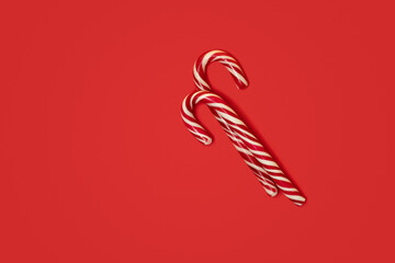 Christmas candy cane on a red background.
