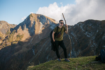 A guy with a backpack in the mountains.