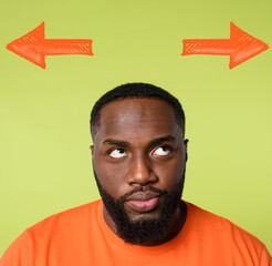 Confused black Man has to choose the right arrow to follow. Concept of options, confusion, decision.