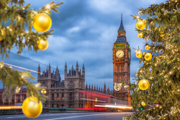 Fototapeta na wymiar Big Ben with Christmas tree on bridge at night in London, England, United Kingdom