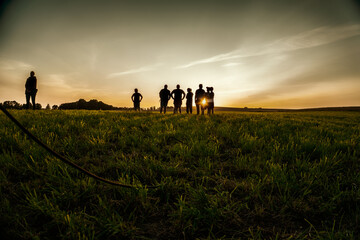 a group of people at sunset