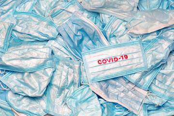 Covid-19 concept. Spread Coronavirus. Dangerous garbage. Medical waste. Mask conceptual. Contagious. Coronavirus background. Pandemic concept. Medical mask texture background. Used mask. Wave covid