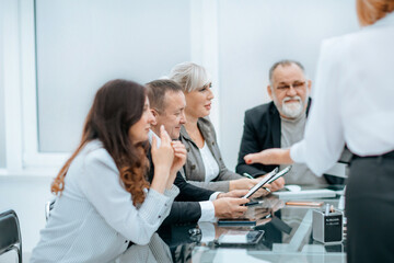 working group discussing business documents at a working meeting