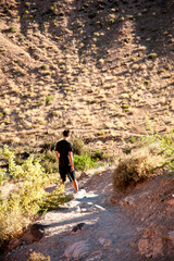 Hiker ascends down a trail in Rock Rock Canyon