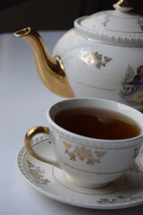 Tea hour, drinking tea, cup of tea with teapot