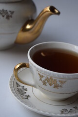 Tea hour, drinking tea, cup of tea with teapot