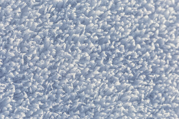 Winter, snow and frost, surface structure of a winter landscape with large crystals, white background.