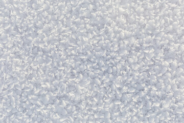 Winter, snow and frost, surface structure of a winter landscape with large crystals, space texture, white background.