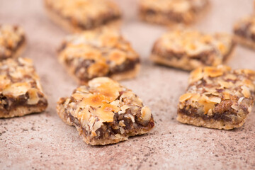 Confectioneries with nuts and chocolate, german christmas sweets, little cakes on a brown textured background, empty copy space for text