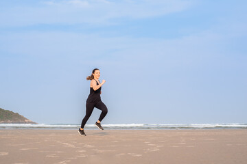 Woman running on the beach	
