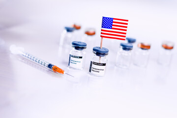 Vials of the coronavirus vaccine with the American flag to cure Covid-19.