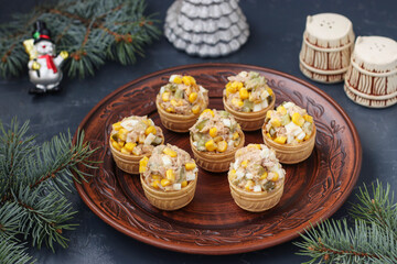 Tartlets with tuna, corn and eggs on a plate on dark background, Horizontal format, Closeup