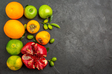 top view fresh pomegranate with apples and tangerines on dark background ripe fruit color
