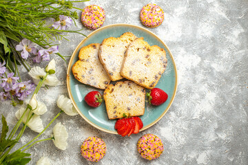 top view yummy cake slices with strawberries on light floor pie sweet cake