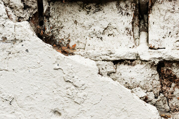Empty old brick walls texture close-up. Painted problem wall surfaces. Grunge Red Stone Background. Worn facade of the building with damaged plaster. Abstract web banner.