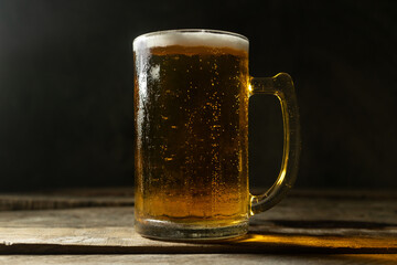 Mug of beer on dark background