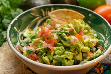 Mexican guacamole on wooden background