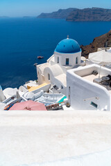 Fototapeta na wymiar Architecture and landscape of the Santorini island., famous luxury travel vacation getaway. Oia white village with Blue Domes and mills. Amazing warm sunny day