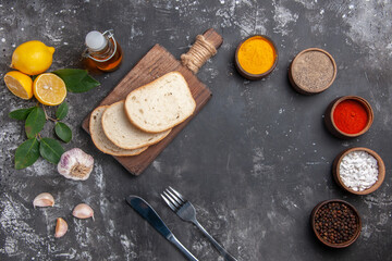 Fototapeta na wymiar top view white bread slices of it with seasonings on grey background meal food photo