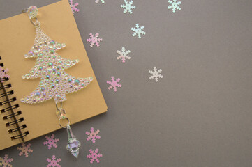Happy New Year and Merry Christmas, festive layout with notepad, christmas pearl tree on gray...