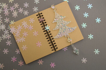 Happy New Year and Merry Christmas, festive layout with notepad, christmas pearl tree on gray...
