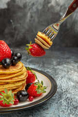 front view delicious pancakes with fruits and berries on a dark background dessert fruit cake