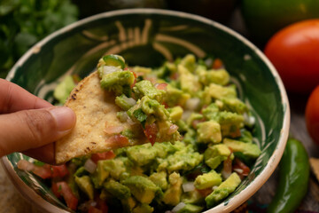 Mexican guacamole on wooden background