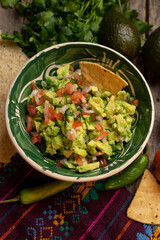 Mexican guacamole on wooden background