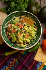 Mexican guacamole on wooden background