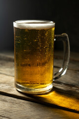 Mug of beer on dark background