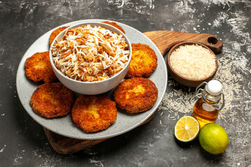 front view tasty fried cutlets with cooked rice on dark background meat rissole dish