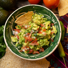 Mexican guacamole on wooden background