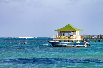 
Tourist hut in the middle of the sea with a boat for tourists
