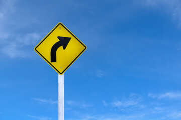 Turn right sign, traffic sign ign on white pole with clouds and blue sky background.