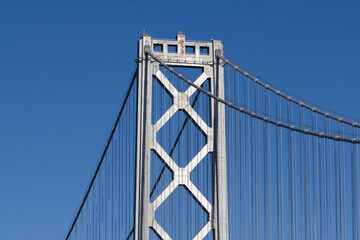 Closeup of a suspension tower and the cantilever of the western section of the San Francisco Oakland Bay Bridge.