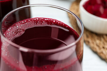Fresh beet juice in glass on table, closeup
