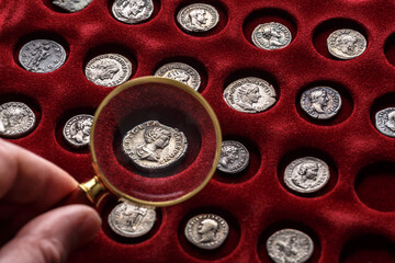 Numismatics.Authentic silver denarius, antoninianus of ancient Rome. A collector holds an old...