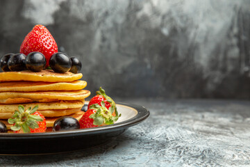 front view delicious pancakes with fruits and berries on a dark background fruit cake dessert