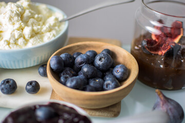 Still life of blueberries on a wooden bowl