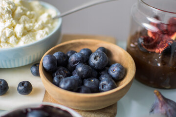 Still life of blueberries on a wooden bowl