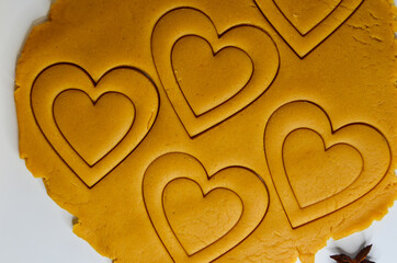 heart shape cut out of raw dough for valentine's day holiday, homemade baking concept, cookie cutter shape