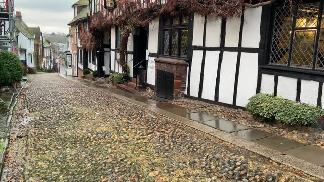 RYE, EAST SUSSEX, ENGLAND - AUGUST 14, 2020: The medieval Mermaid Inn built in Rye in1420 along cobble stone Mermaid Street, Rye, East Sussex, UK