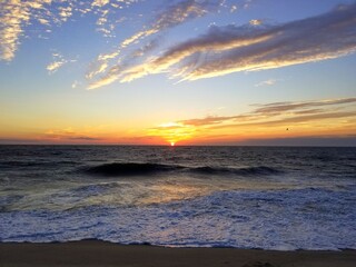 Fototapeta premium Beautiful sunrise and waves in the early morning near Dewey Beach, Delaware, U.S.A