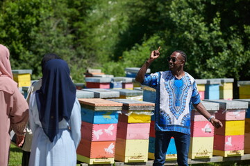 people group visiting local honey production farm