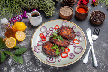 Fototapeta na wymiar top view yummy meat cutlets with seasonings on light-grey floor meal photo dish