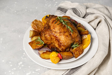 Нoliday food roast chicken or poultry with potatoes and vegetables on a white plate. dish for family dinner or lunch Christmas New Year Thanksgiving