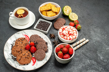 top view choco biscuits with candies and tea on dark background sweet cookies photo