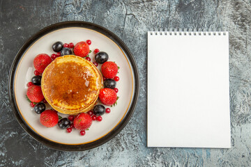 top view yummy pancakes with fruits and honey on light desk fruit breakfast sweet